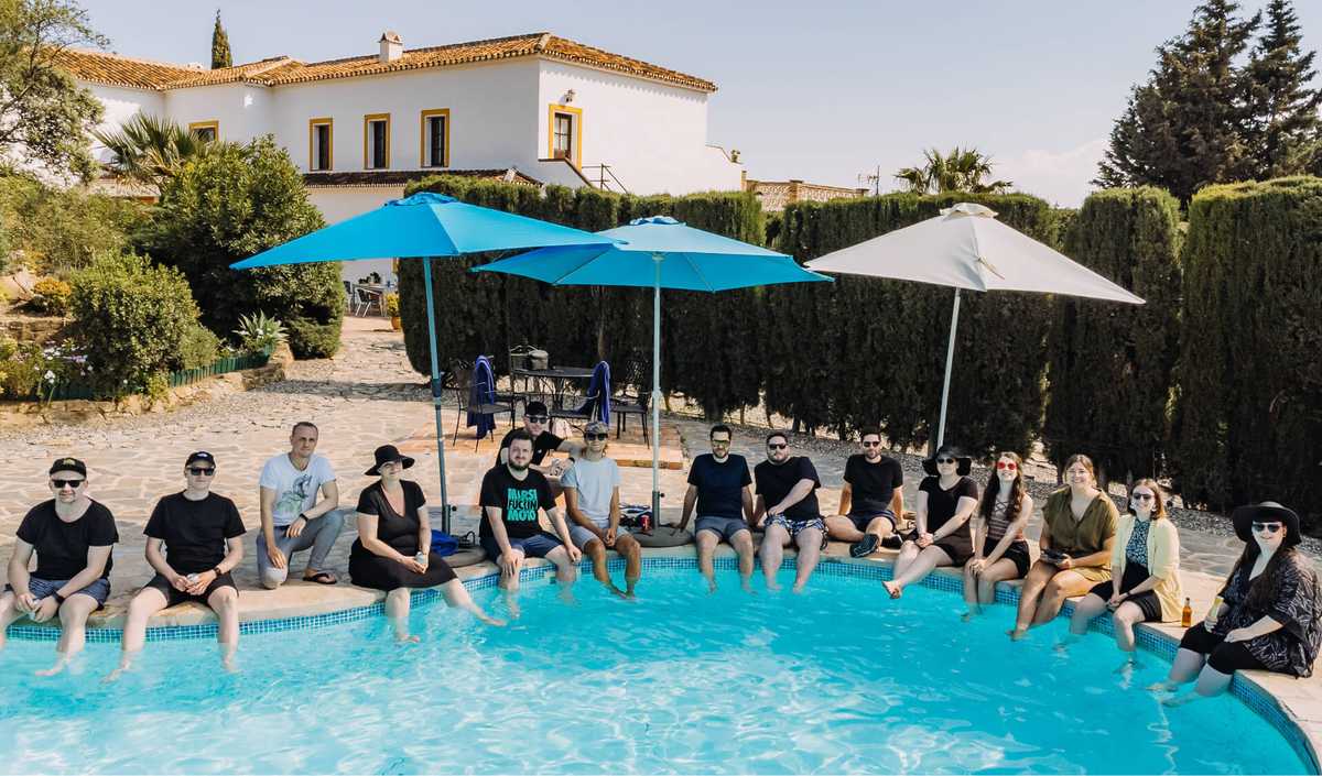 The whole team sitting at the pool